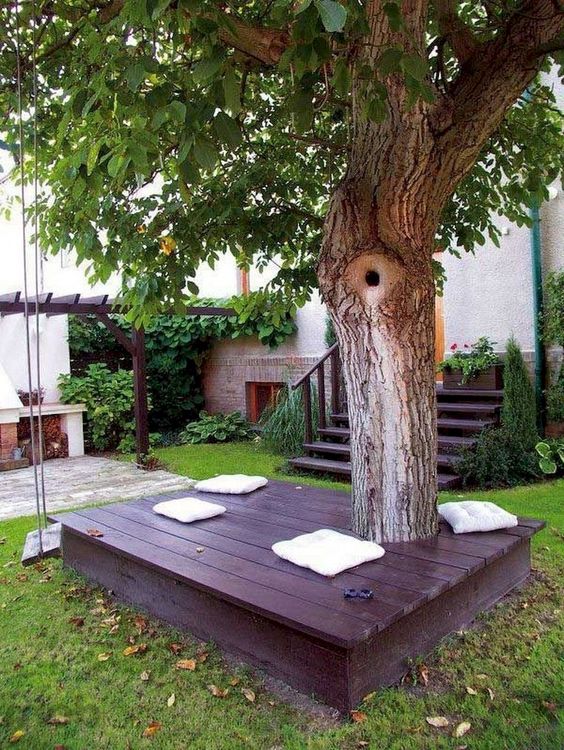 Wooden lounge under the tree - backyard playground ideas